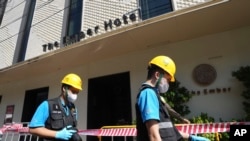 Police forensics team arrive at a hotel in Bangkok, Thailand, Dec. 30, 2024, a day after a fire killed three people. 