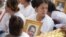 Bou Rachana, the late Kem Ley's wife, sobs while holding a portrait of her late husband at a funeral procession, Phnom Penh, Cambodia, Sunday, July 24, 2016. (Leng Len/VOA Khmer)