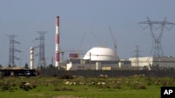 FILE - The reactor building of Iran's nuclear power plant and electricity poles are seen, at Bushehr, Iran, Feb. 27, 2005. 