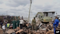 FILE—A bulldozer demolishes houses on riparian land in the Mukuru area of Nairobi, Kenya, May. 7, 2024. 