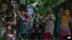 Kashmiri village women grieve as they watch the funeral procession of rebel leader Sabzar Ahmed Bhat in Retsuna 45 Kilometers south of Srinagar, Indian controlled Kashmir, May 28, 2017. 