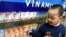 FILE - A Vietnamese boy looks at dairy products at a showroom of the Vietnam Dairy Products Co (Vinamilk) in Hanoi.
