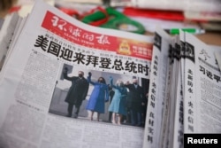 A copy of the Global Times newspaper featuring an image of U.S. President Joe Biden and Vice President Kamala Harris on its front page is seen at a news stand in Beijing, China, Jan. 21, 2021.