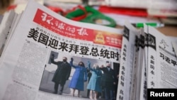 A copy of the Global Times newspaper featuring an image of U.S. President Joe Biden and Vice President Kamala Harris on its front page is seen at a news stand in Beijing, China, Jan. 21, 2021.