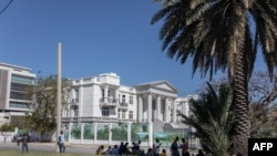 Journalists gather outside the Supreme Court of Haiti (Cours de cassation)on February 8, 2021 in the almost empty streets of Port-au-Prince.
