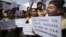 Indian school children hold placards and shout slogans during a protest against the deadly shooting attack at a Sikh temple in Wisconsin, in Jammu, Aug. 6, 2012. 