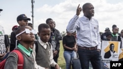 FILE—Songezo Zibi (R), the leader of the South African political party Rise Mzanzi, gestures as he addresses supporters for a community meeting in Eden Park, Alberton, on April 12, 2024.