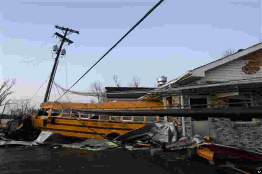 A school bus is pushed through the front of a building after a tornado swept through Henryville, Ind., Friday March 2, 2012. The storm was part of a system that brought high winds and heavy rain to parts of Indiana, Kentucky and Tennessee. (AP Photo/Phi