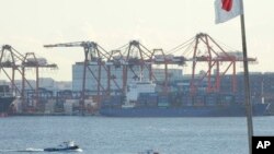 FILE - A tug boat goes by the pier of a container terminal in Tokyo, Jan. 25, 2017. Talk of a possible 20 percent tax on U.S. imports from Mexico is raising eyebrows in Asia, where exports to the U.S. drive growth in many economies. 