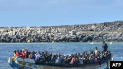 FILE — Migrants arrive on a boat at La Restinga dock in the municipality of El Pinar on the Canary Island of El Hierro, Oct. 21, 2023. The number of people arriving in Spain's Canary Islands so far this year has neared a record.