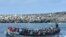 FILE — Migrants arrive on a boat at La Restinga dock in the municipality of El Pinar on the Canary Island of El Hierro, Oct. 21, 2023. The number of people arriving in Spain's Canary Islands so far this year has neared a record.