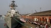 File - Indian school children walk past the visiting Indian Navy warship INS Kirch for a guided tour in Kolkata, Dec. 5, 2019. India is sending four navy ships for exercises and port visits in the Indo-Pacific region as China's maritime power grows.