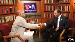 VOA’s Somali Chief Abdirahman Yabarow (left) greets President Hassan Sheikh Mohamud 