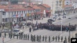 Paramilitary policemen (bottom) and policemen block the street during a protest in Xilinhot, Inner Mongolia Autonomous Region, in this handout photo dated May 23, 2011.