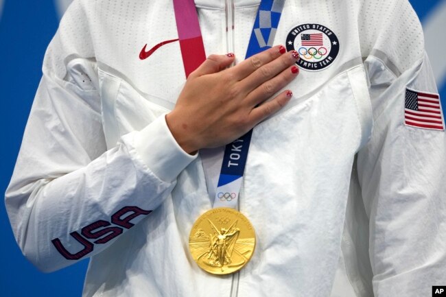 FILE - Katie Ledecky of the United States with her gold medal after winning the women's 1500-meters freestyle final at the 2020 Summer Olympics, on July 28, 2021, in Tokyo, Japan. (AP Photo/Matthias Schrader, File)