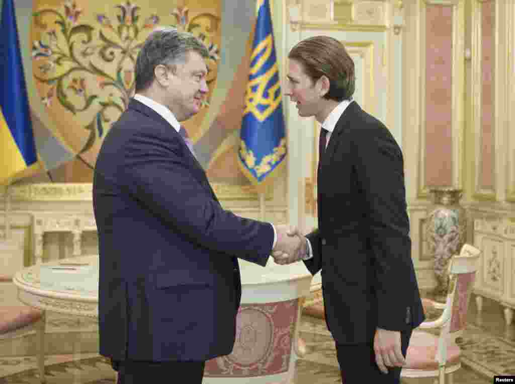 Ukrainain President Petro Poroshenko (left) shakes hands with Austrian Foreign and Integration Minister Sebastian Kurz during a meeting in Kyiv, Sept. 15, 2014.