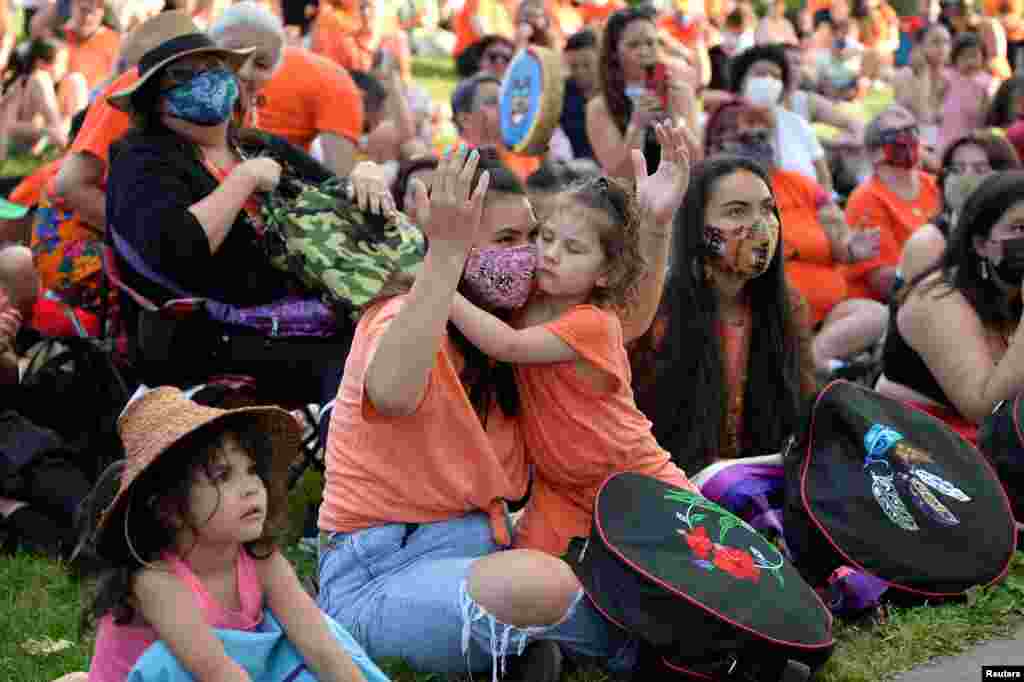 People listen to speakers after the remains of 215 children, some as young as three years old, were found at the former Kamloops Indian Residential School, during a vigil in Vancouver, British Columbia, Canada, June 2, 2021.