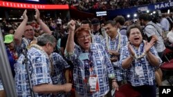Guam delegates react as some delegates call for a roll call vote on the adoption of the rules during the opening day of the Republican National Convention in Cleveland, July 18, 2016. 