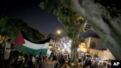 Israelis and Palestinians protest after two cemeteries, one Muslim and the other Christian, were vandalized by graffiti in the mixed Arab Jewish neighborhood of Jaffa, Israel, October 8, 2011.