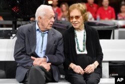FILE - Former President Jimmy Carter and Rosalynn Carter are seen ahead of an NFL football game between the Atlanta Falcons and the Cincinnati Bengals in Atlanta, Georgia, Sept. 30, 2018.