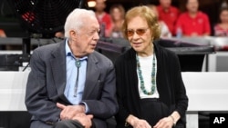 FILE - Former President Jimmy Carter and Rosalynn Carter at an NFL football game between the Atlanta Falcons and the Cincinnati Bengals in Atlanta, Georgia, Sept. 30, 2018.