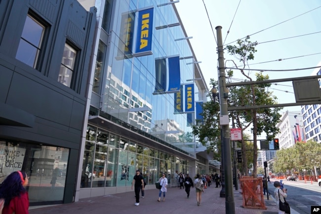 People walk along Market Street past the new IKEA store on its opening day in San Francisco, Wednesday, Aug. 23, 2023. (AP Photo/Eric Risberg)