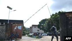 Members of the Sierra Leonean Police Forces guard the entrance to the Sierra Leone Broadcasting Corporation in Freetown on November 27, 2023.