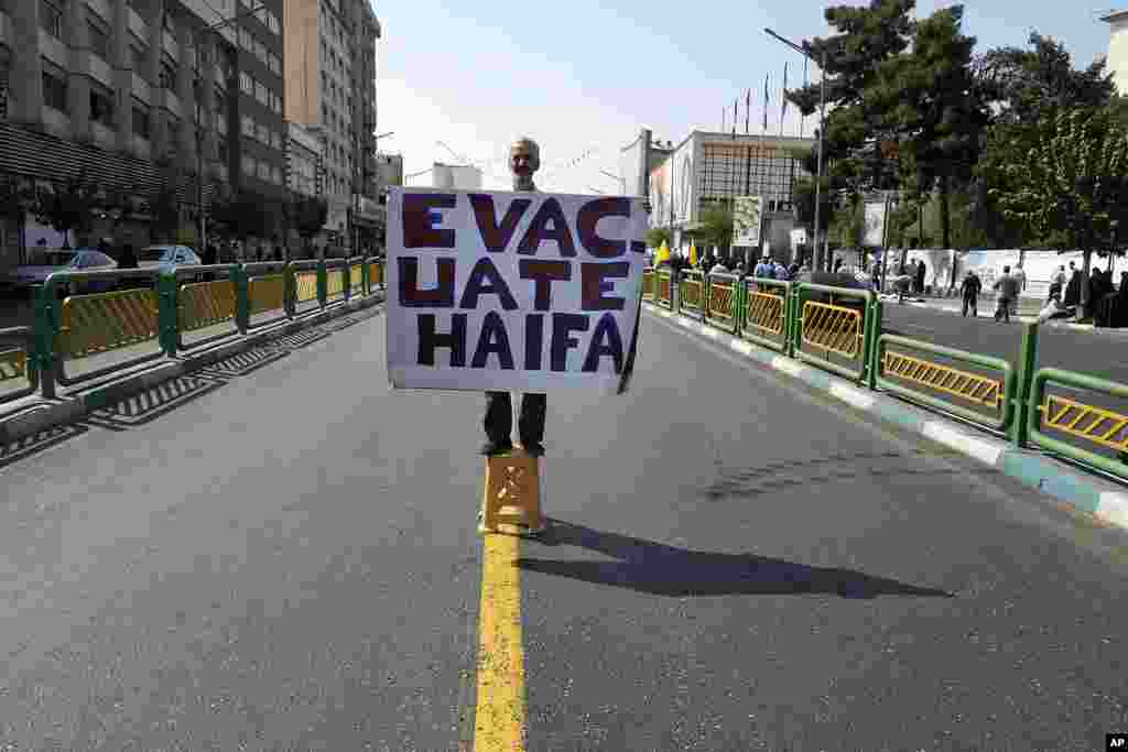 A man holds an anti-Israel placard calling for the evacuation of the northern Israeli city of Haifa, during a rally to support Lebanon&#39;s militant Hezbollah group and Palestinians after Friday prayers in Tehran, Iran.