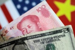 FILE - U.S. Dollar and China Yuan notes are seen in this picture illustration, June 2, 2017.