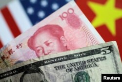 FILE - U.S. Dollar and China Yuan notes are seen in this picture illustration, June 2, 2017.