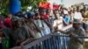 FILE - Haitians cross the border into Dajabon, Dominican Republic, Friday, May 17, 2024. 