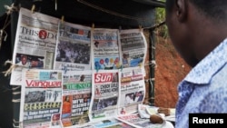 Newspapers with various front page headlines on the Chibok girls and their possible release are displayed at a news stand in Abuja, Oct. 18, 2014. 