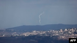 A picture taken from northern Israel shows flares launched by the Israeli army over the southern Lebanese village of Khiam on Sept 16, 2024.