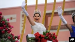 FILE - Rose Queen Victoria Castellanos waves to the crowd at the 128th Rose Parade in Pasadena, Calif., Jan. 2, 2017. 