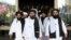Members of a Taliban delegation, led by chief negotiator Mullah Abdul Ghani Baradar, center, leave after peace talks with Afghan senior politicians in Moscow, May 30, 2019.