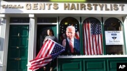 FILE - Catherine Hallahan waits for the celebrations to start in Ballina, North West of Ireland, Nov. 7, 2020. Ballina is the ancestral home of U.S. presidential candidate Joe Biden.