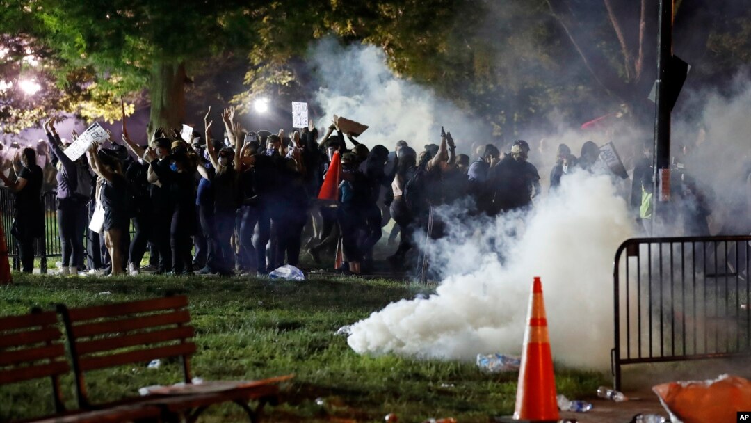 Tear gas billows as demonstrators gather in Lafayette Park to protest the death of George Floyd, May 31, 2020, near the White House in Washington.