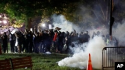 Tear gas billows as demonstrators gather in Lafayette Park to protest the death of George Floyd, May 31, 2020, near the White House in Washington.