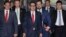 U.S. Treasury Secretary Steven Mnuchin, center, escorted by bodyguards and a delegation leaves a hotel in Beijing, March 29, 2019. 