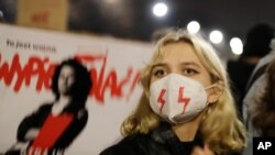 Young people take part in a massive protest against the conservative government, the latest angry demonstration triggered by a recent tightening of the abortion law, in Warsaw, Poland, Oct. 30, 2020.