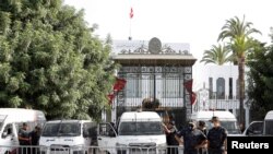 Police officers stand guard outside the parliament building in Tunis, Tunisia, July 27, 2021. 