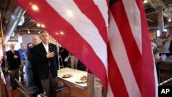 Republican 2012 presidential candidate, former Utah Gov. Jon Huntsman says the Pledge of Allegiance at the Laconia Rotary luncheon in Laconia, New Hampshire, Thursday, Dec. 29, 2011.