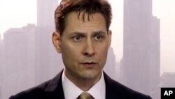 FILE -Image made from a video on March 28, 2018 shows Michael Kovrig, an adviser with the International Crisis Group, a Brussels-based non-governmental organization, speaking during an interview in Hong Kong. 