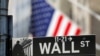 FILE PHOTO: A street sign for Wall Street is seen outside the New York Stock Exchange (NYSE) in New York City