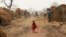 FILE - A child walks through a refugee camp in Kaga-Bandoro, Central African Republic, Feb. 16, 2016.