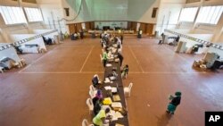 Electoral workers engage in vote tally verification process at National Tallying Center in Nairobi, Kenya March 6, 2013