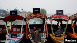 Uber signs are displayed on &quot;Shikaras&quot; or small boats after Uber launched its first water transport service on the waters of Dal Lake, one of Kashmir&#39;s main tourist attractions, in Srinagar, India.
