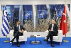Turkish President Recep Tayyip Erdogan meets with Greece's Prime Minister Kyriakos Mitsotakis on the sidelines of the NATO summit, in Brussels, Belgium, June 14, 2021. (Murat Cetinmuhurdar/Presidential Press Office/Handout via Reuters)