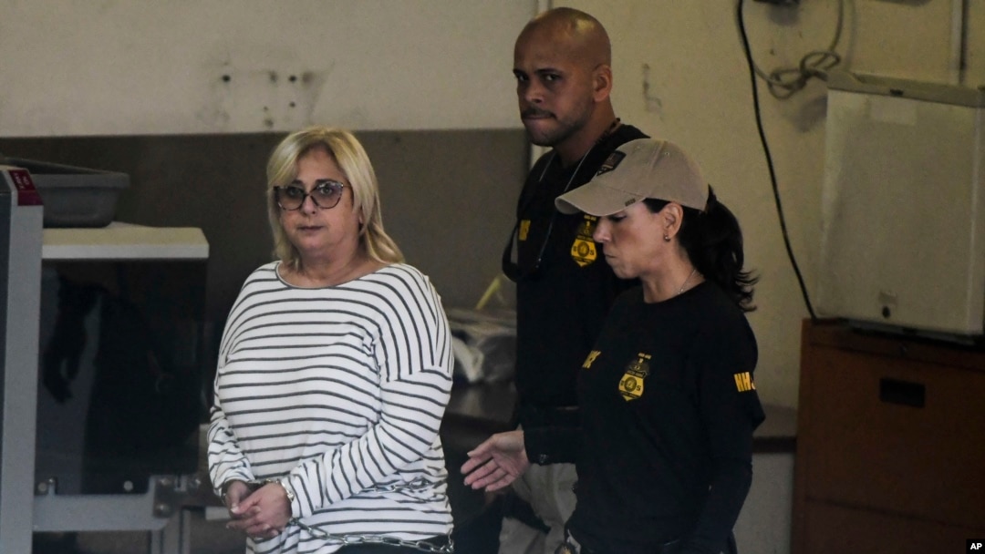 Federal agents escort former Puerto Rico Health Insurance Administration head Ángela Ávila-Marrero who was arrested in San Juan, Puerto Rico, July 10, 2019. 