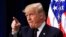 President Donald Trump acknowledges applause as speaks during a conference supporting veterans and military families through partnership at the Eisenhower Executive Office Building at the White House complex in Washington, Nov. 15, 2018. 